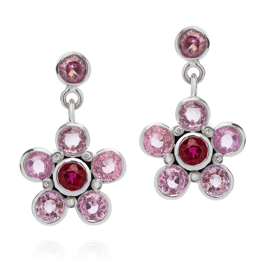 Pink Sapphire, Ruby, & Diamond Earrings on a silver clasp with the ruby gemstone at the centre and four pink sapphire gemstones circled on the outside of the ruby centre with 5 small diamonds on each earring| Augustine Jewels | Gemstone jewelry