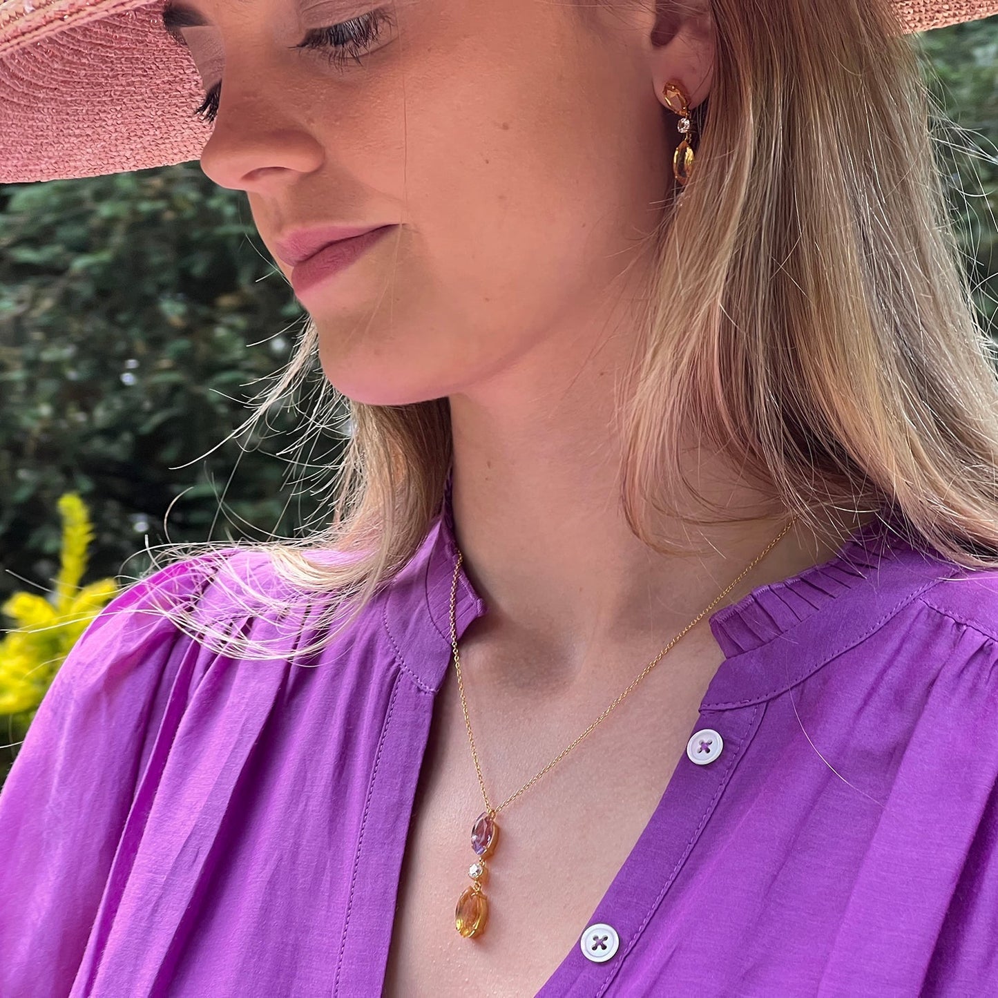 Model wearing purple amethyst, citrine and white topaz drop necklace 