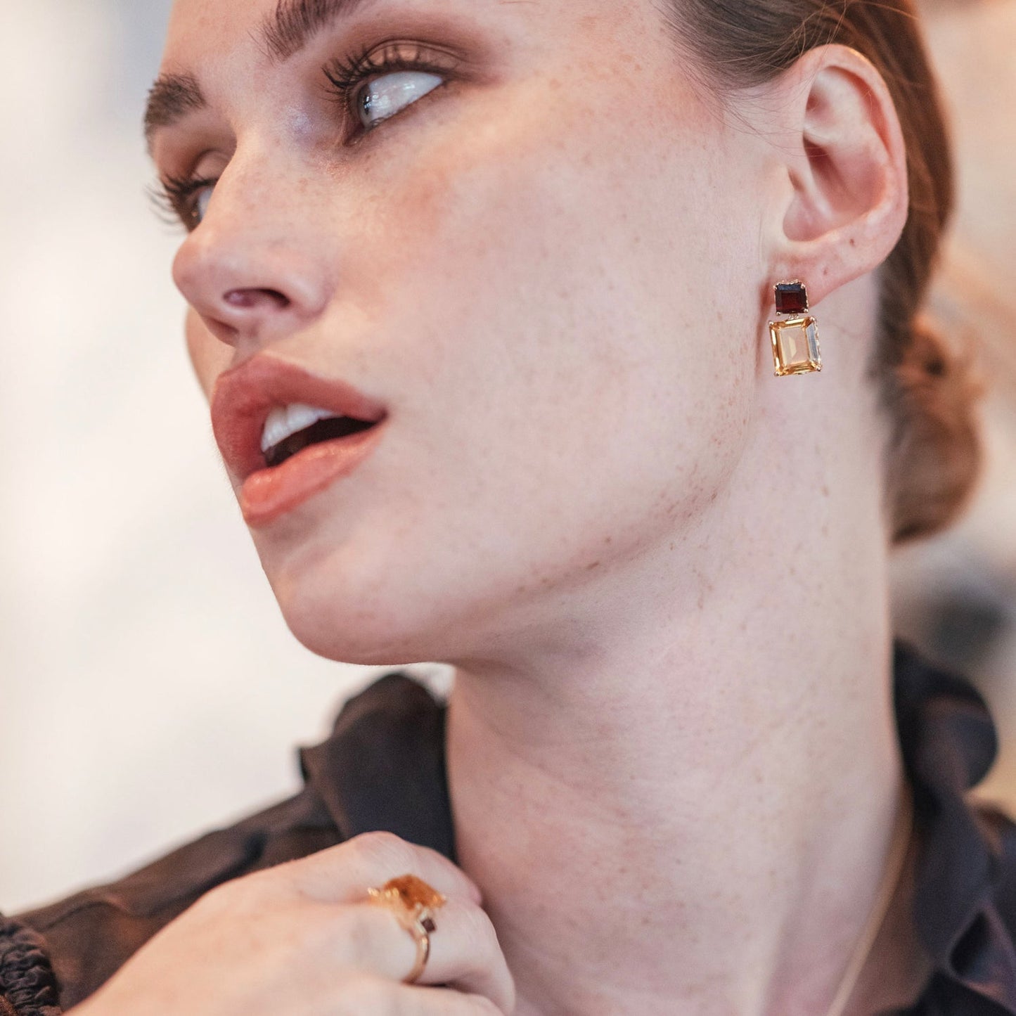 Side view of model wearing Octagon Gold Drop Earrings in Garnet & Citrine