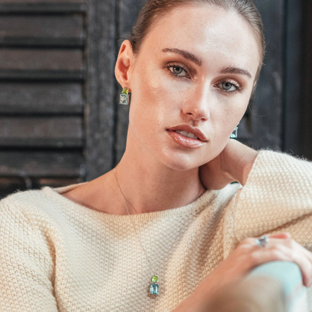 
                  
                    Model wearing Octagon Gold Drop Earrings in Peridot & Blue Topaz
                  
                