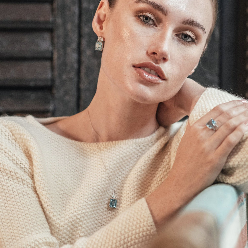 
                  
                    Model wearing Octagon White Gold Drop Earrings in White Topaz & Blue Topaz
                  
                