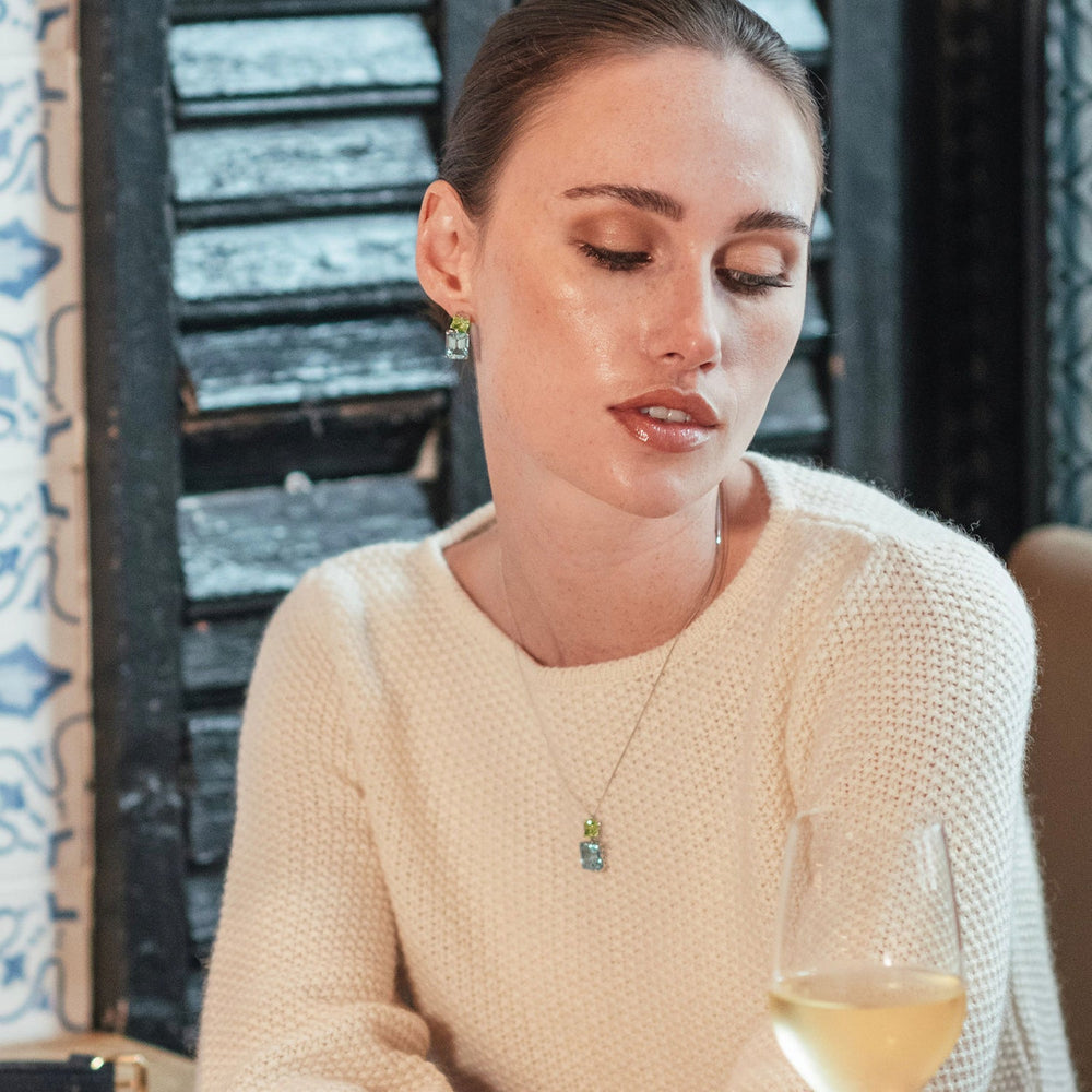 
                  
                    Model wearing Octagon Gold Drop Earrings in Peridot & Blue Topaz
                  
                