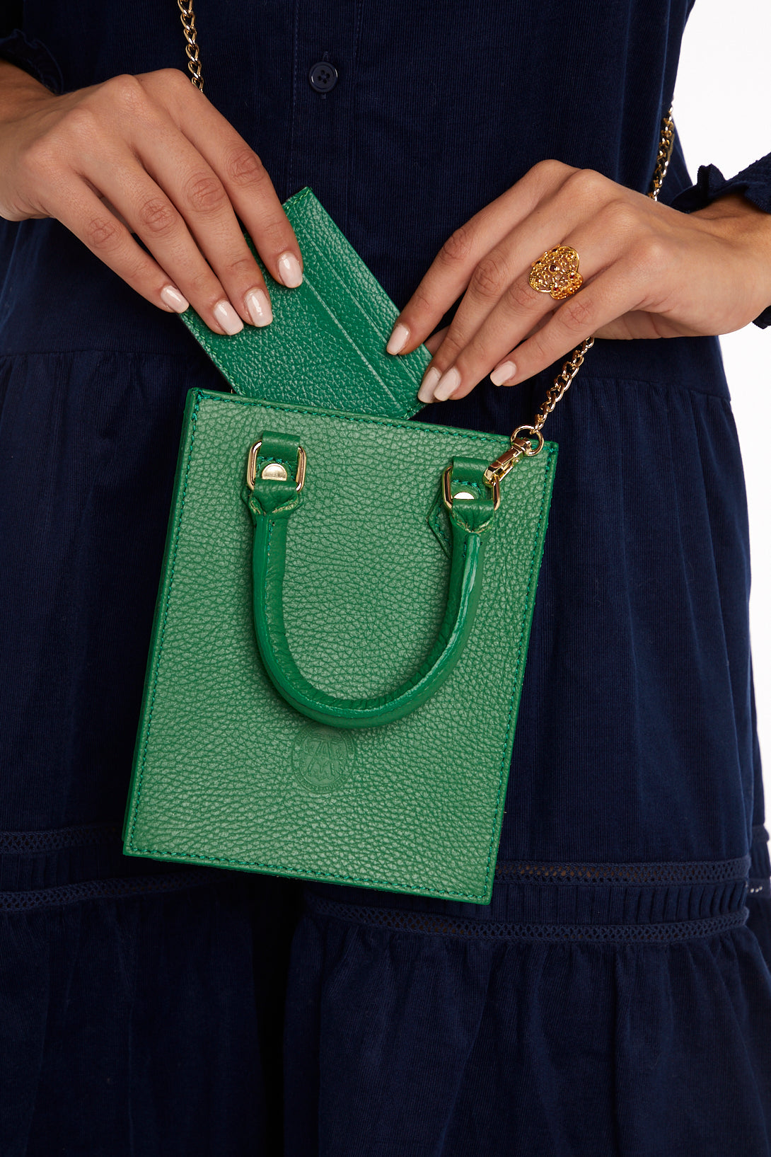 Model holding small green bag