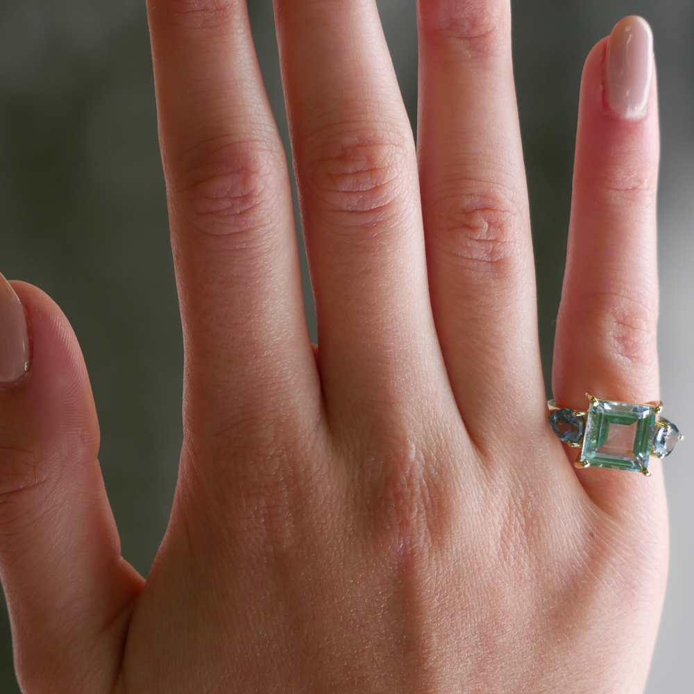 Model wearing Sky Blue Topaz and Pear Teal Topaz Ring