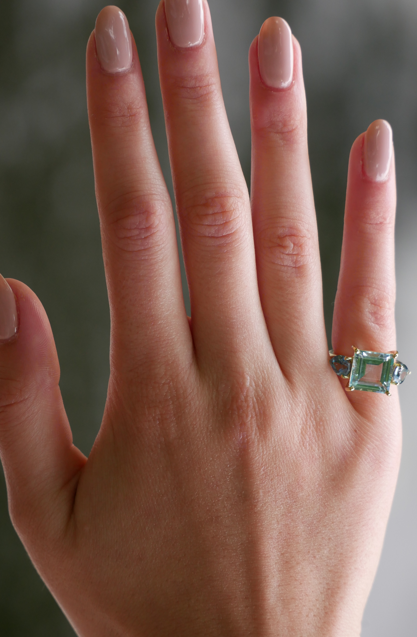 Model wearing Sky Blue Topaz and Pear Teal Topaz Ring
