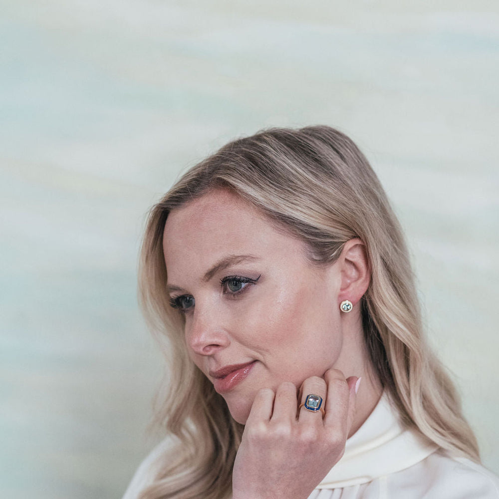 
                  
                    Model wearing Sky Blue Topaz and White Enamel Stud Earrings
                  
                