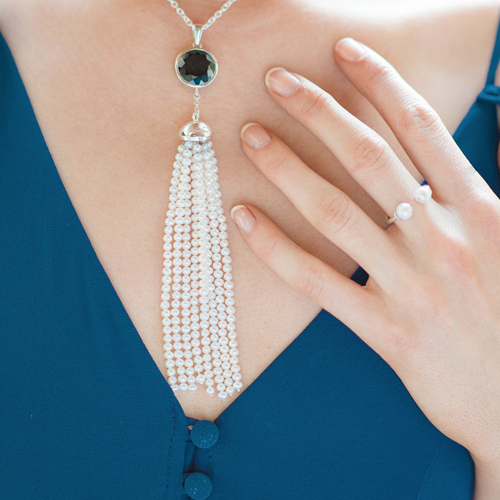 
                  
                    Model wearing spinal & pearl tassel necklace
                  
                